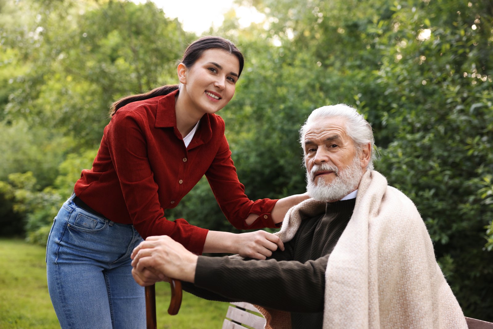woman helping senior man on park bench 2026 09 22 11 27 54 utc
